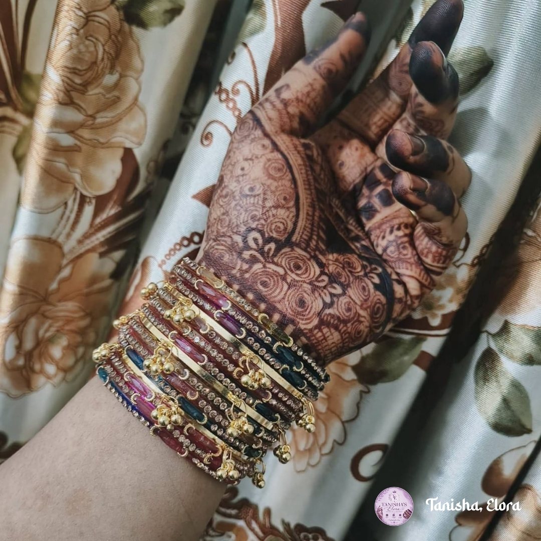 Bride's henna-covered hand layered with matching handmade Churi bangles
